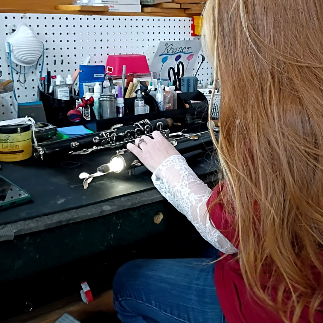 Technician working on an instrument in the repair facility
